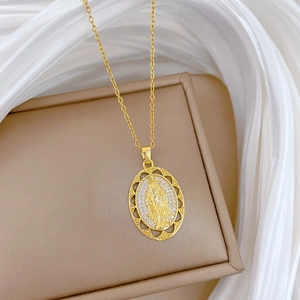 Detail of gold egg-shaped necklace with central figure relief and sparkling diamond pavé
