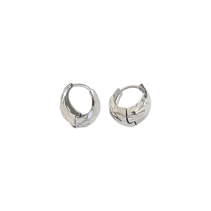 Polished silver geometric hoop earrings with textured facets on white background