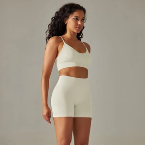 Detail der nahtlosen Rippenstrick-Textur am hafermehlfarbenen Sport-BH und den Yoga-Shorts