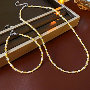 Detailed set of 18k gold and silver plated bead necklace and bracelet in a display box