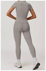 Back view of gray slim-fit short sleeve top and high-waist yoga leggings set for women