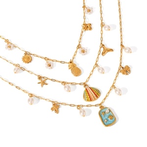 Gold layered necklace set with pearls, starfish pendants and blue enamel charms