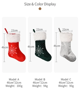Détail de chaussettes de Noël en velours avec broderie de flocon et bordure en fausse fourrure