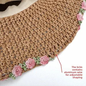 Detail of straw hat brim with floral embroidery and flexible inner wire for shaping