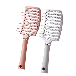 Pink and grey curved vented hairbrushes for scalp massage and hair styling on white background