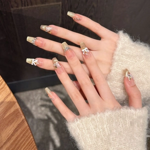 Long coffin press-on nails with golden glitter, 3D butterfly, and dancing lion charms