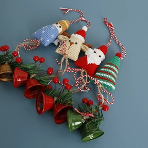 Handmade crochet Christmas charms featuring Santa, reindeer, and tree with bells