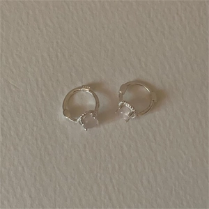 Detail of S925 sterling silver hoop earrings with a pink cat eye stone inlay