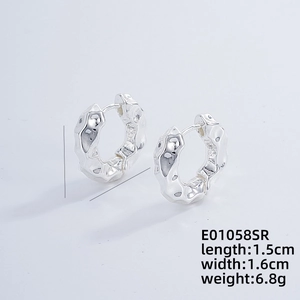 Detail view of irregular silver hoop earrings with size 1.5cm by 1.6cm dimensions