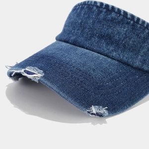 Distressed denim sun visor hat with ripped edge detailing in a vintage blue wash