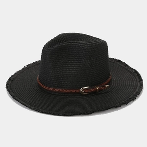 Close-up of black straw hat featuring woven leather belt and frayed tassel edge