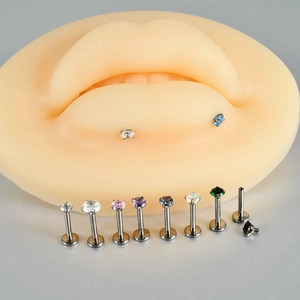 G23 titanium labret stud with multi-colored zircon stones on a silicone lip model