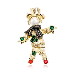 Detailed macro view of gold-tone scarecrow brooch with colorful rhinestones and white pearl