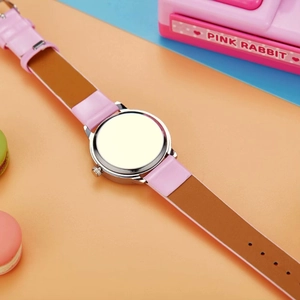 Close-up of child's silent quartz watch case back with pink and brown split strap design