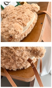 Close-up of soft brown plush teddy bear bag showing zipper and adjustable strap