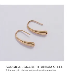 Macro shot of 18K gold plated titanium steel water drop earrings with high polish finish