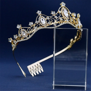 Detailed view of luxury bridal crown with crystals and hair comb on blue background