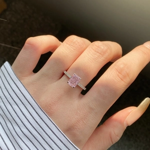 Detailed close-up of a pink rectangular cushion-cut gemstone set on a silver pavé ring