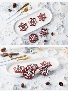 Macro detail of snowflake cookie cutter with festive 3D red icing snowflake cookies