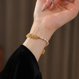 Elegant gold bracelet with zirconia circles and white pearls on a model wrist