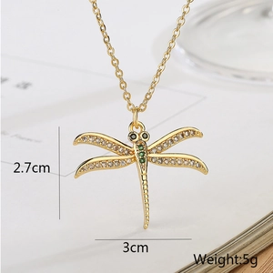 Macro view of 18K gold dragonfly pendant necklace with 2.7x3cm dimensions and 5g weight
