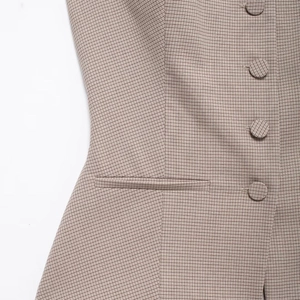 Women's brown houndstooth vest with single-breasted buttons and side pocket detail
