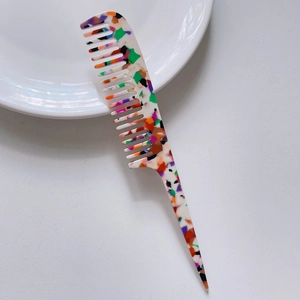 Detail of colorful terrazzo pattern on a long handle pointed tail marble comb