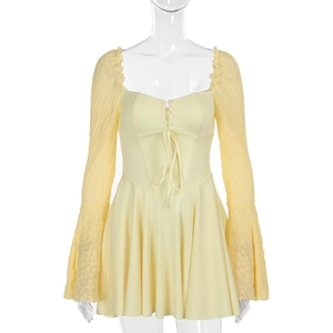 Detail of the square neck and tie-up front on this light yellow lace sleeve dress