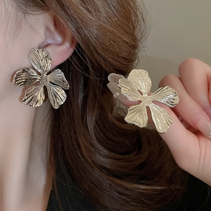 Detailed view of large silver irregular flower petal earrings with liquid metal texture