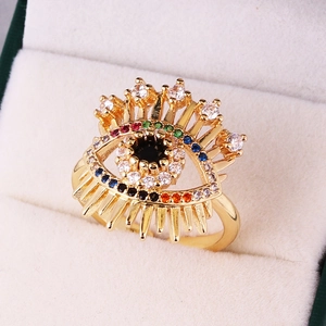 Macro detail of gold evil eye ring with colorful zircon stones and eyelash design