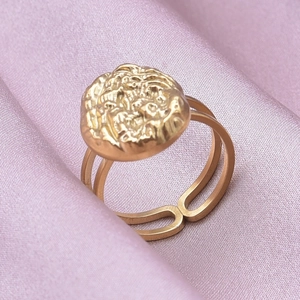 Macro detail of gold textured round disc ring with adjustable double-band design