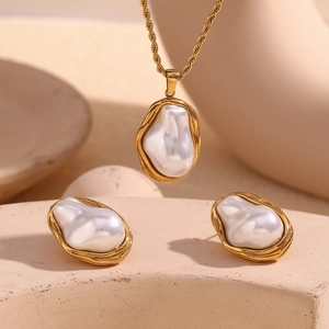 Baroque pearls with textured 18K gold-plated borders on twisted chain necklace and earrings