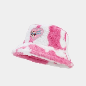 Pink and white cow print plush bucket hat with heart patch embroidery and fluffy texture