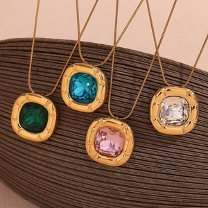 Macro detail of square gemstone necklaces in green, blue, pink and white with gold chains