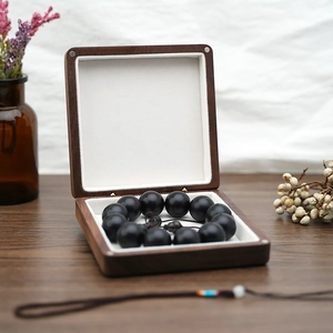 Detail of black prayer beads bracelet inside a luxury solid wood jewelry gift box