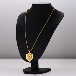Golden punk lion head shield pendant necklace displayed on a black male mannequin torso