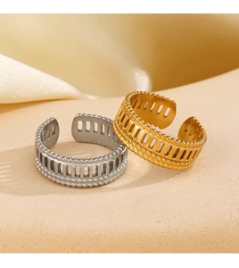 Detail of adjustable hollow striped rings in gold and silver with beaded edges