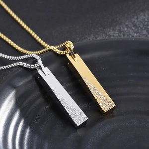 Detail of silver and gold vertical bar pendants with geometric stones on box chains