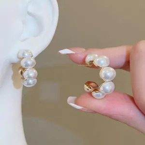Elegant gold-plated C-shape hoop earrings featuring classic white round pearls for women
