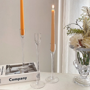 Three-piece clear glass candlestick set in varied heights for romantic table decor