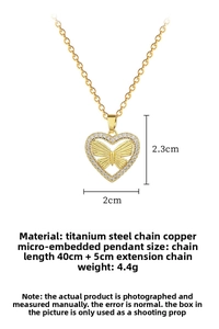 Detail of gold hollow heart necklace with butterfly design and micro-set crystals