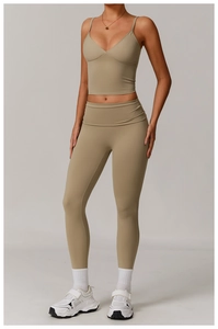Detail of khaki two-piece yoga set with deep V-neck crop top and high-waisted leggings