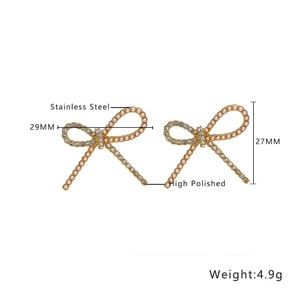 Detail showing dimensions of golden bow earrings with pearls and rhinestones