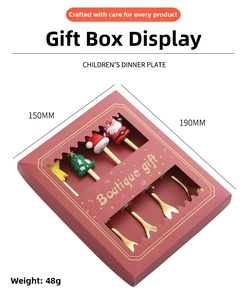 Golden Christmas spoon set with holiday charms in a red window gift box packaging
