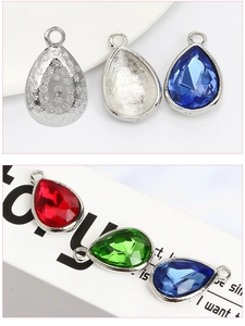 Detailed view of teardrop alloy pendants with colorful crystals and floral metal patterns