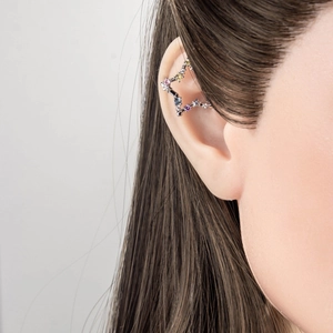 Elegant star earrings with multi-colored cubic zirconia gems worn by a model