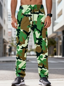 Detail view of cargo pants with jungle camouflage pattern and black adjustable drawstring