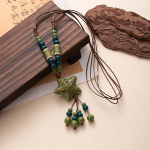 Bohemian ceramic starfish necklace with green beads and brown woven rope decoration