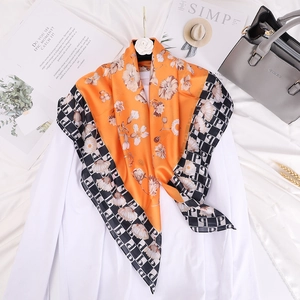 Elegant orange silk shawl with white floral print and checkered border pattern