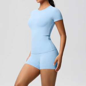 Side view of light blue high-waist yoga shorts and fitted short sleeve sports t-shirt
